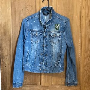 Distressed denim jacket with Tulane University patches. Green Wave!